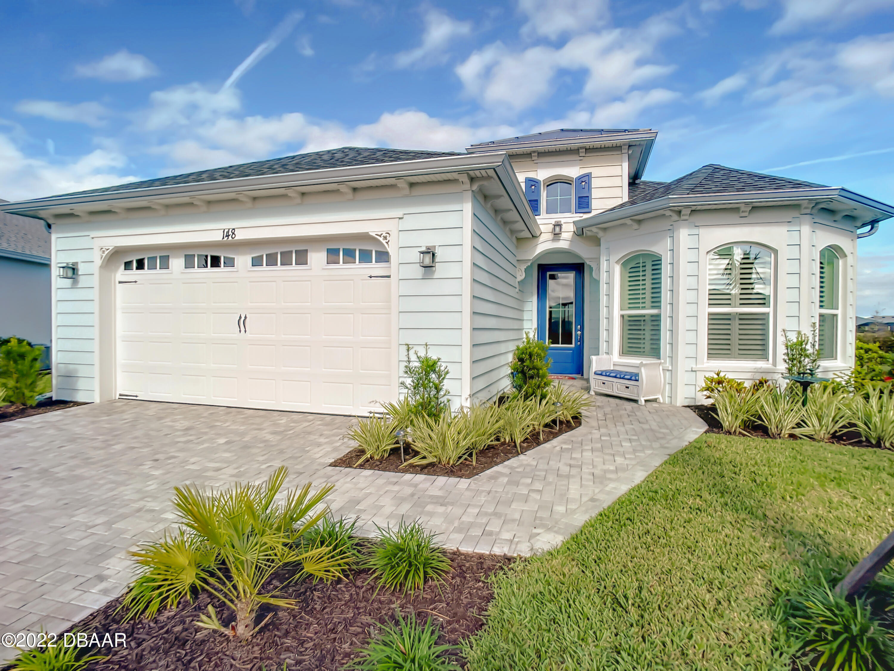 a front view of a house with garden