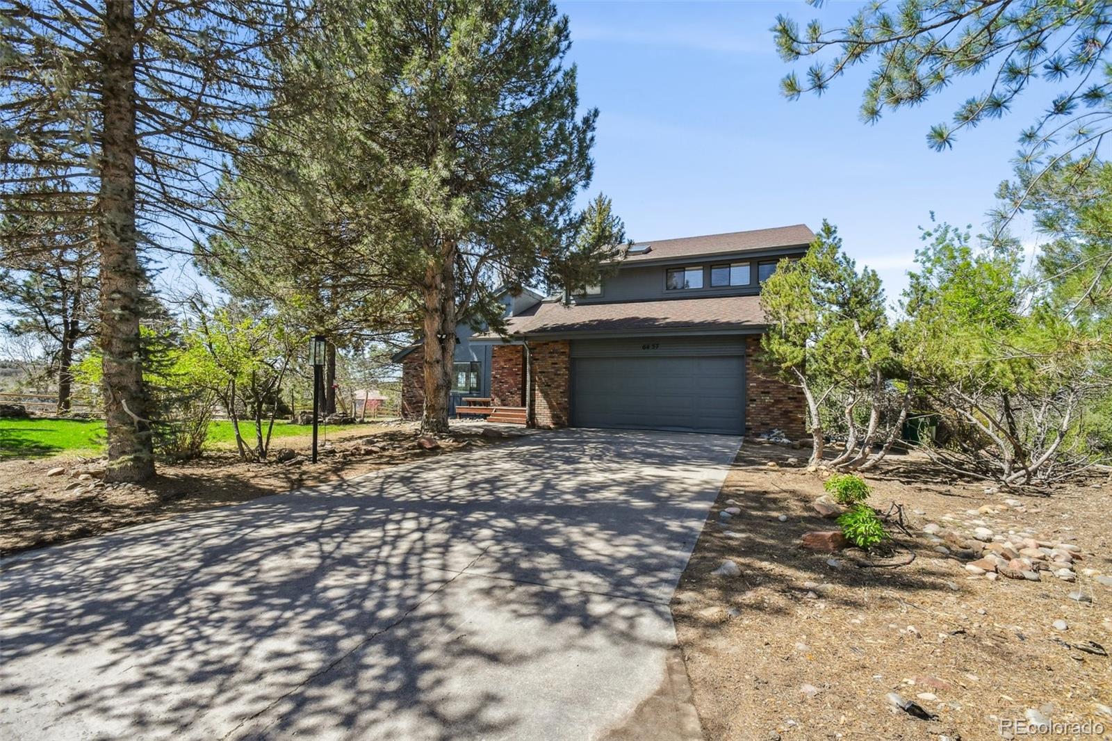 a view of a house with a yard and garage