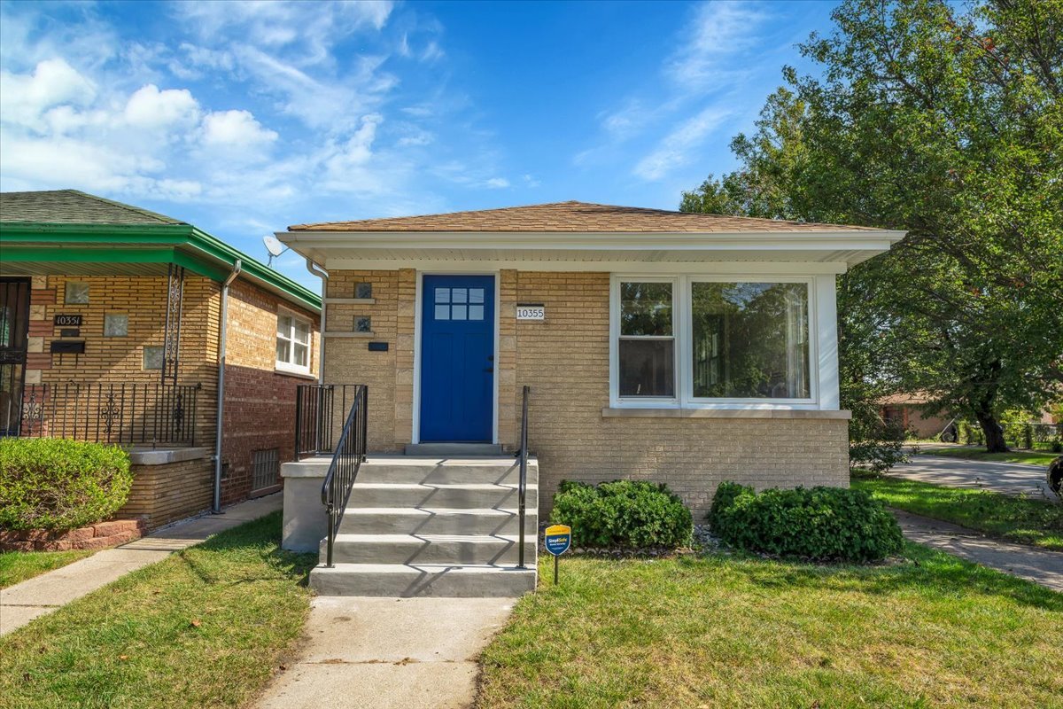 a front view of a house with garden