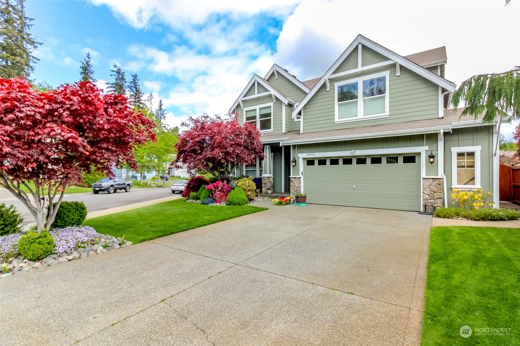 a front view of a house with a yard and garage