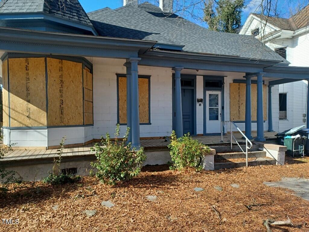 a view of front door of house with outdoor seating