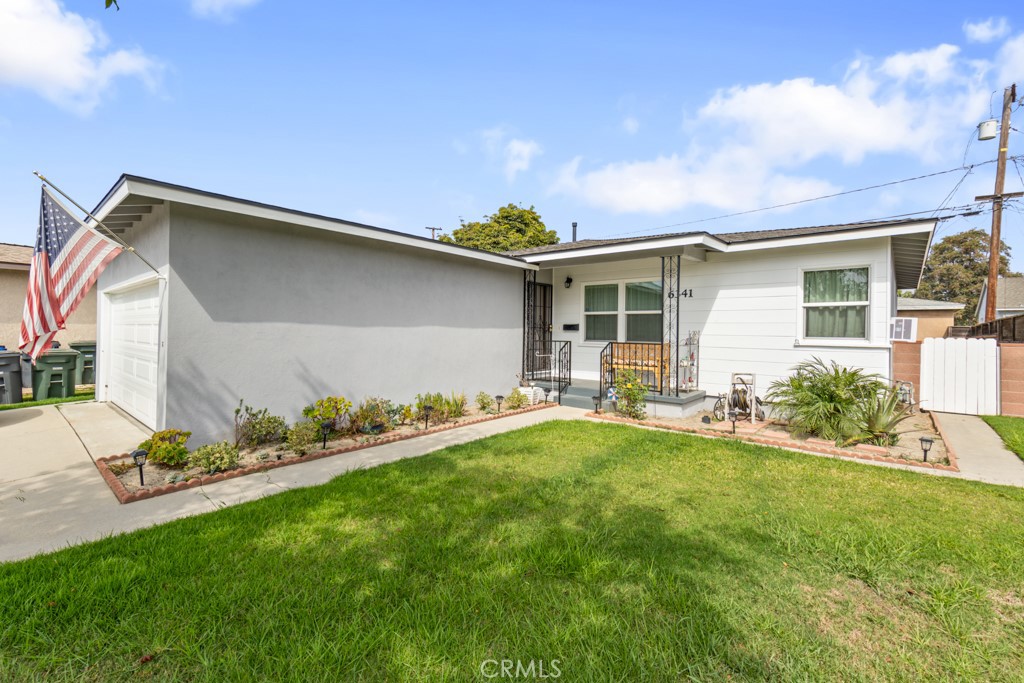 a front view of house with yard and outdoor seating