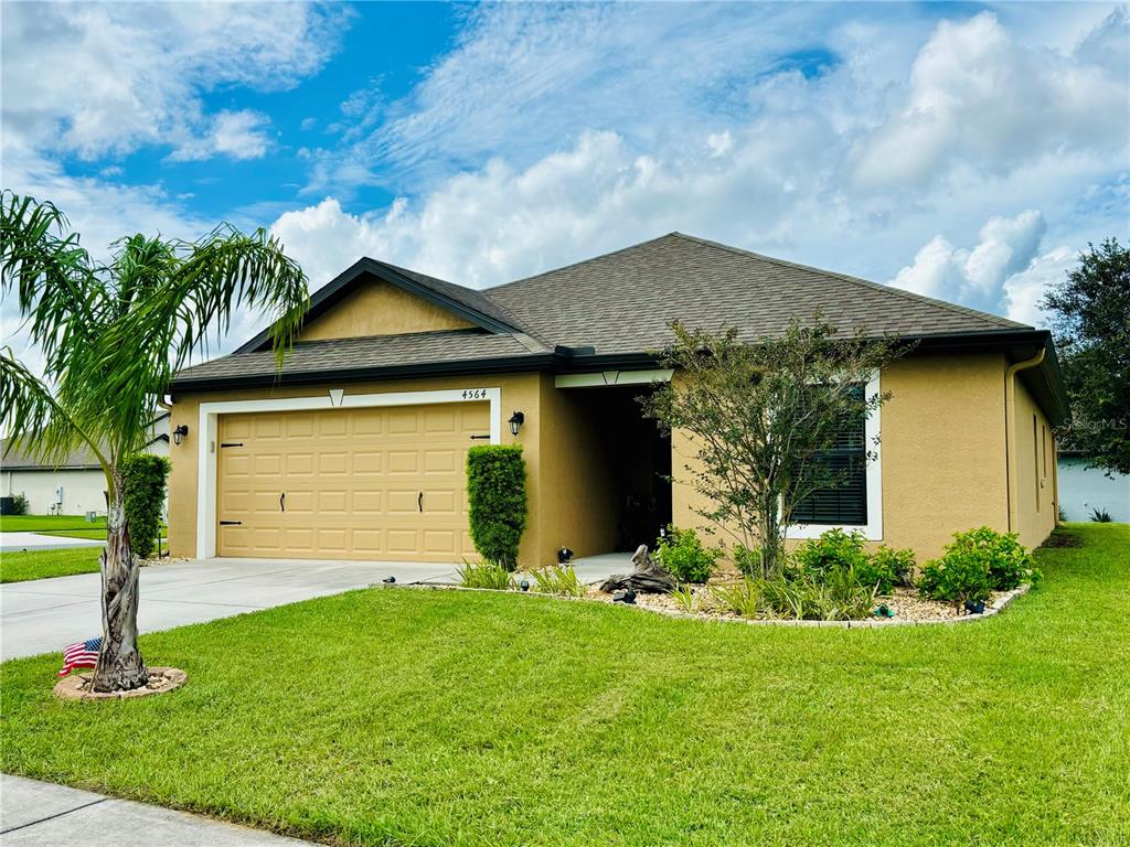 a front view of house with yard and green space