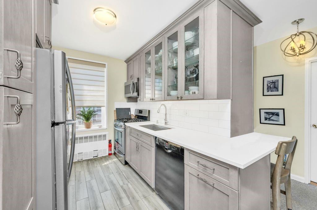 a kitchen with a stove a sink and a refrigerator