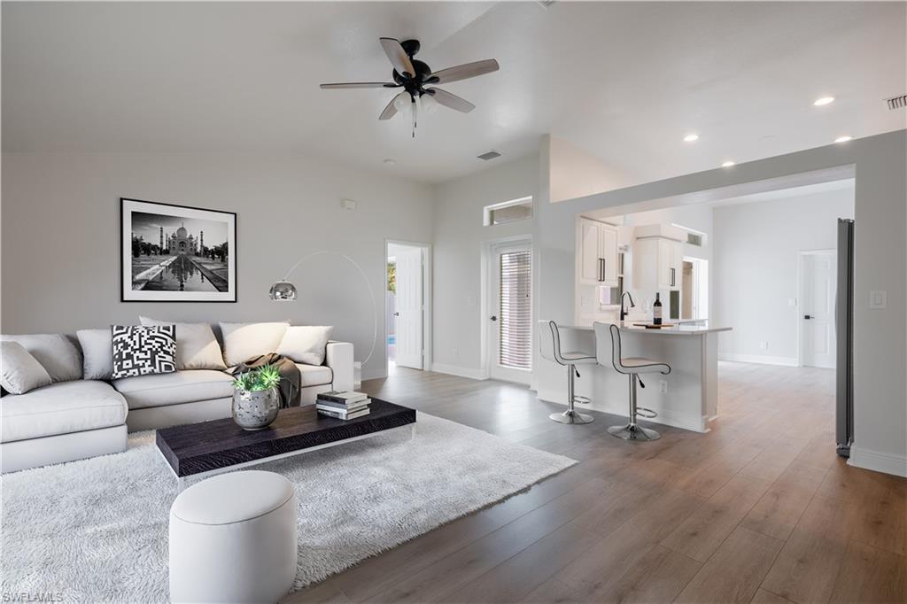 a living room with furniture and a wooden floor