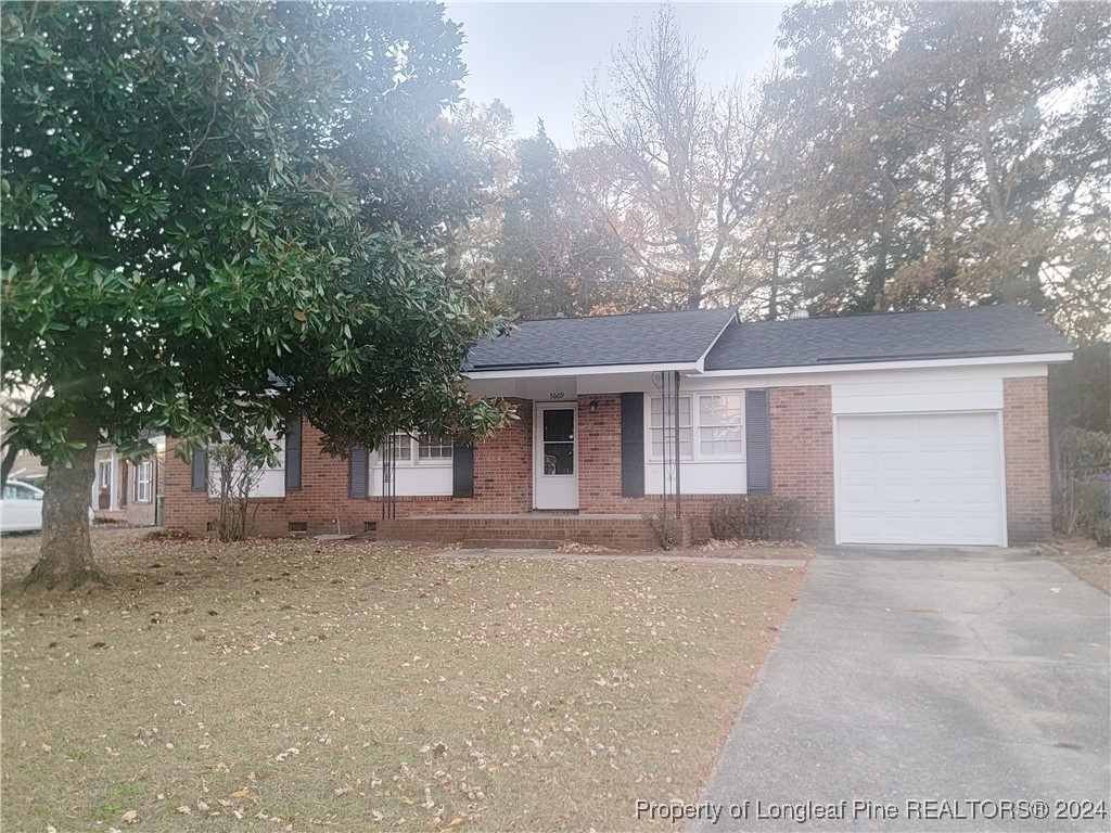 front view of a house with a dry trees