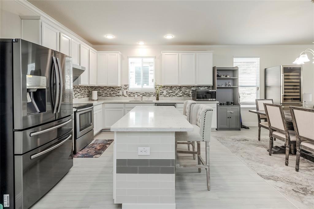 a kitchen with stainless steel appliances granite countertop a stove refrigerator and a refrigerator