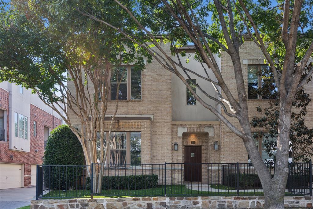 a front view of a house with iron fence