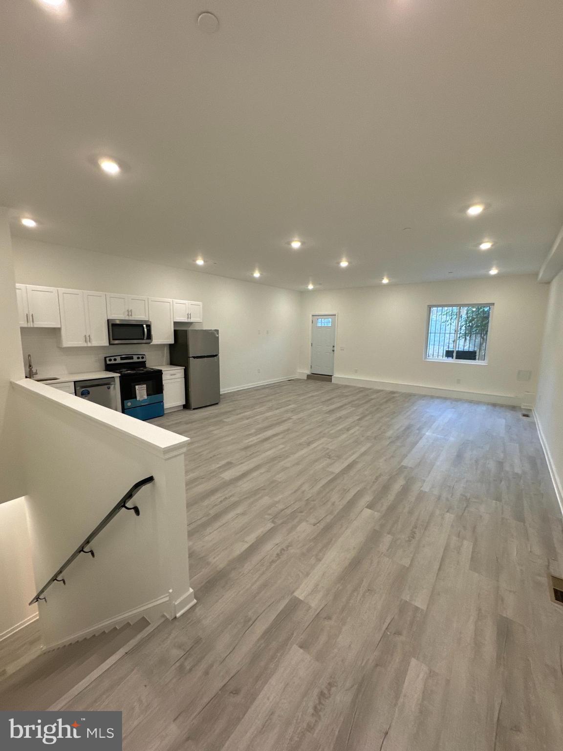 a view of kitchen with cabinets and wooden floor