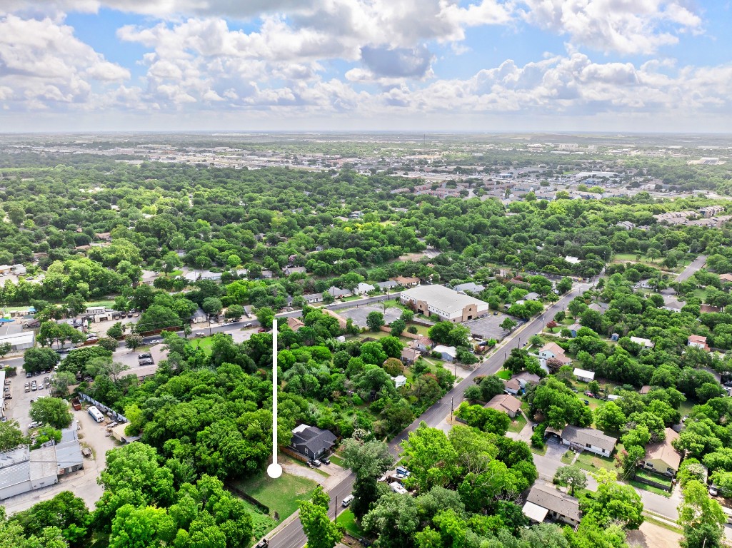 a view of a city with lush green forest