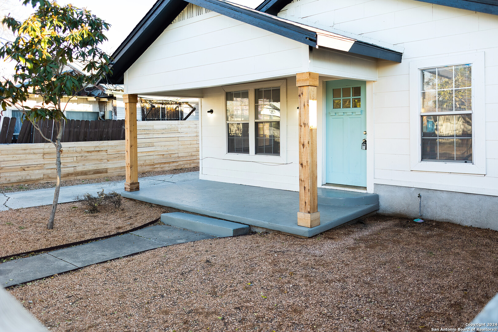 a view of a house with wooden fence