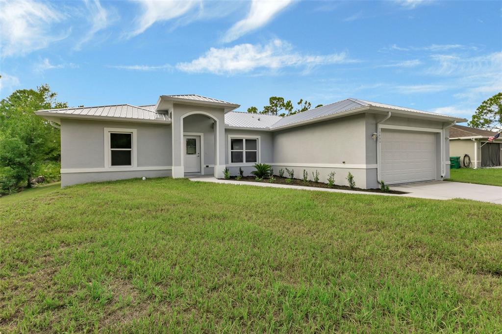 a front view of house with yard and green space