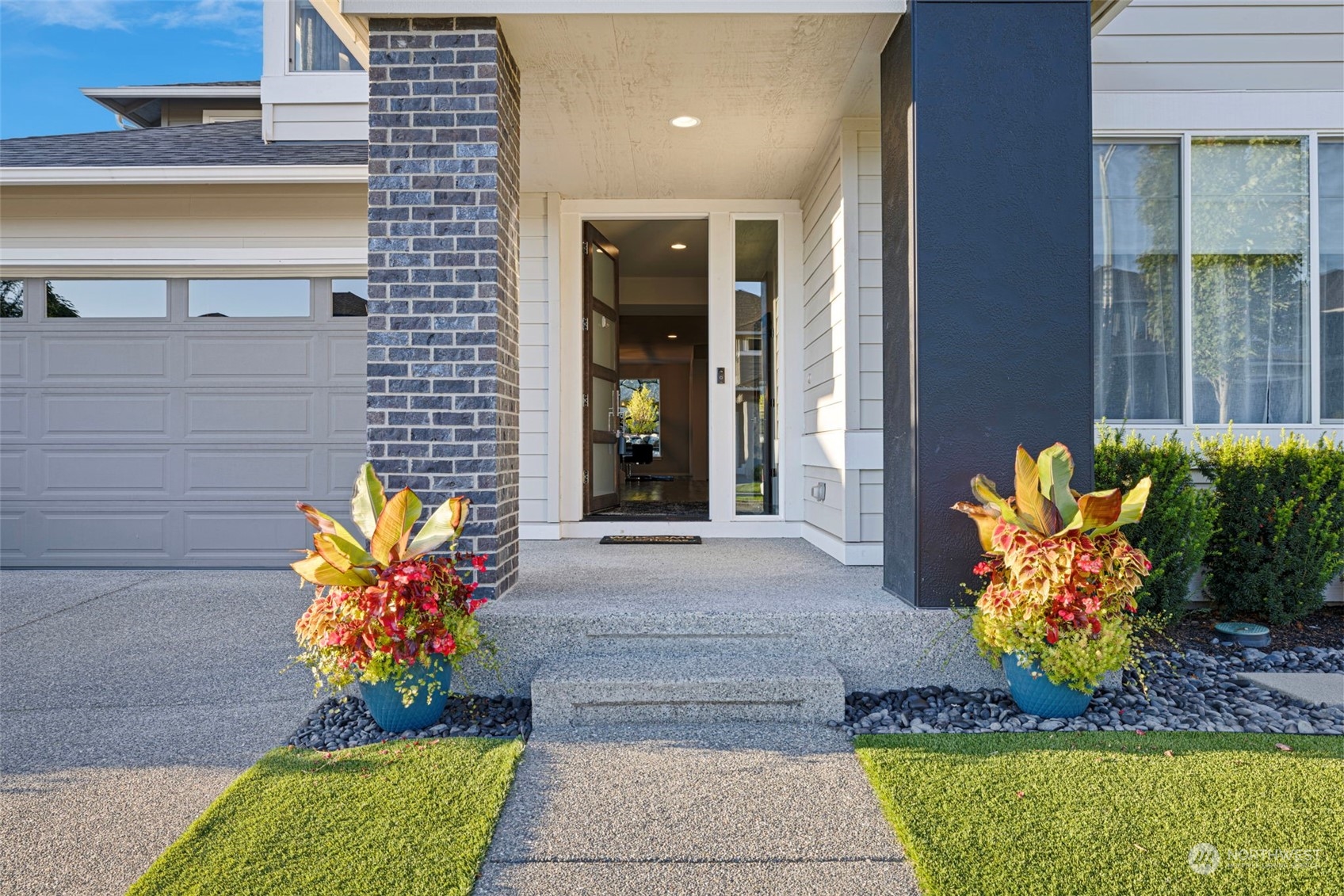 a front view of a house with outdoor seating