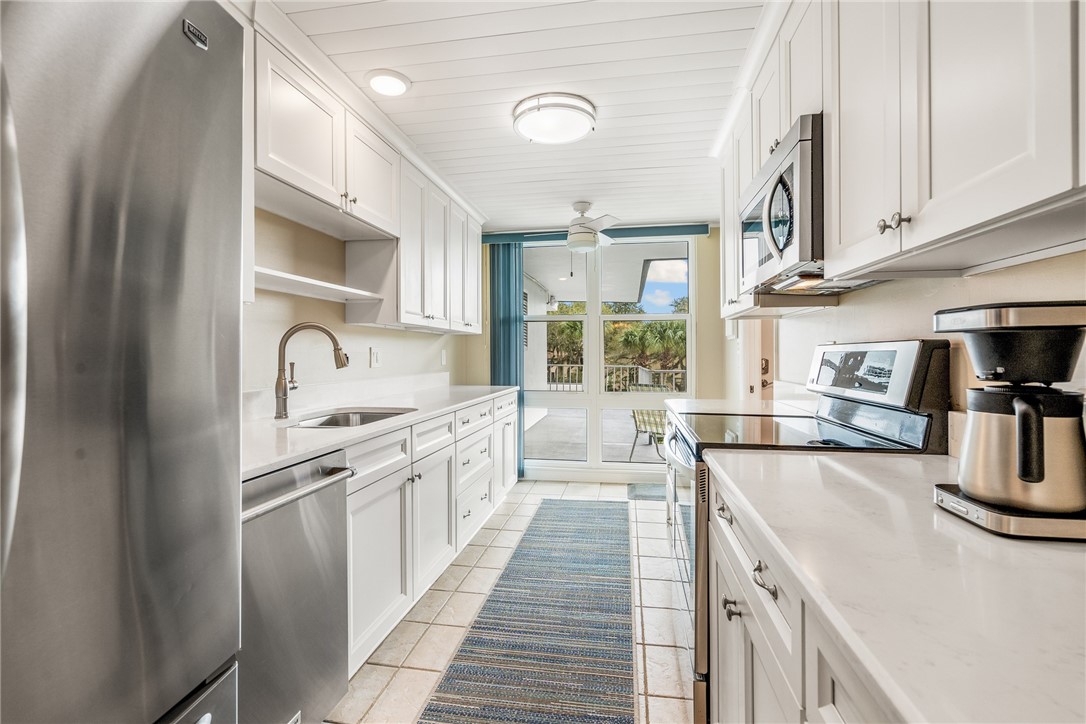 a kitchen with stainless steel appliances granite countertop a sink and cabinets