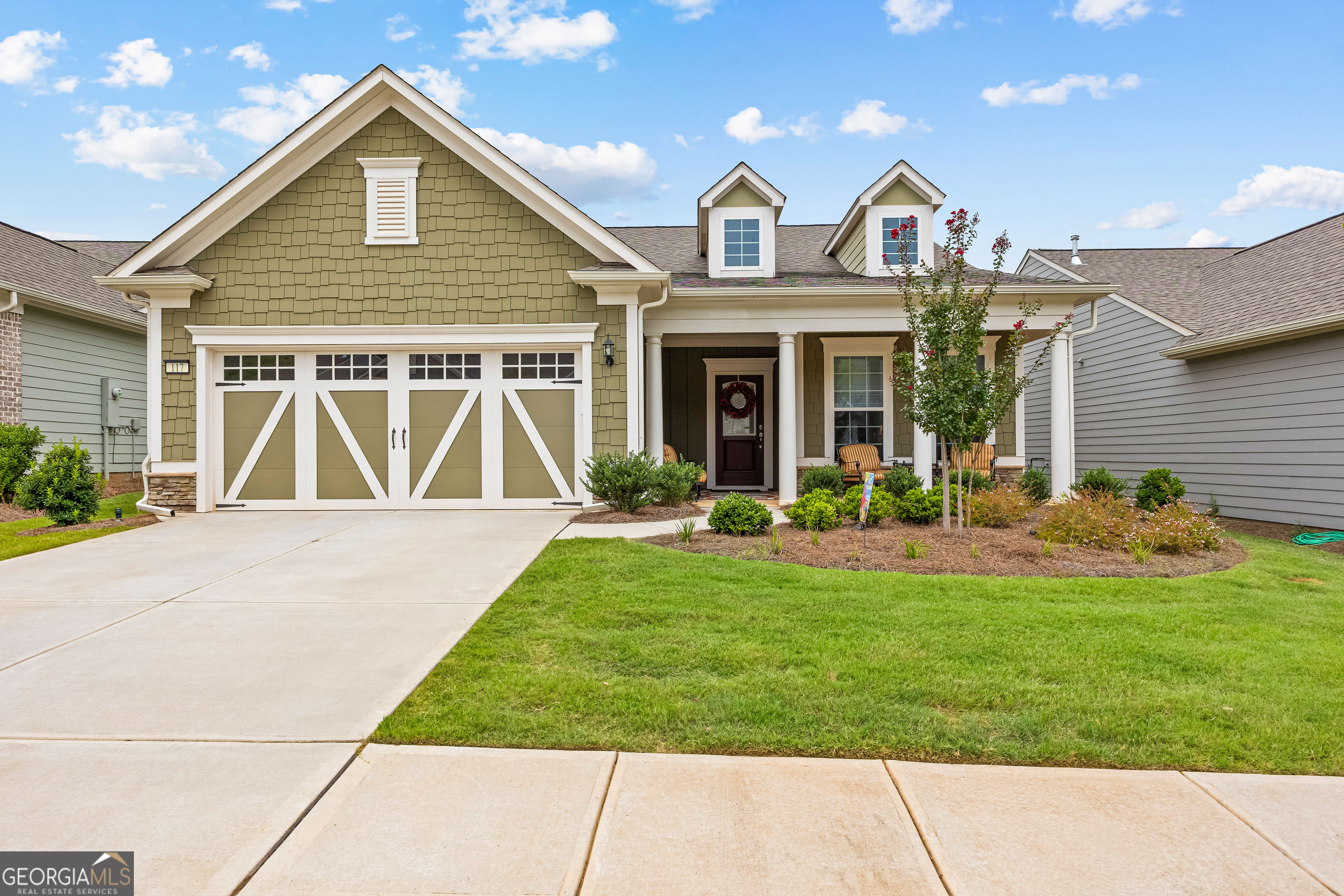 a front view of a house with garden