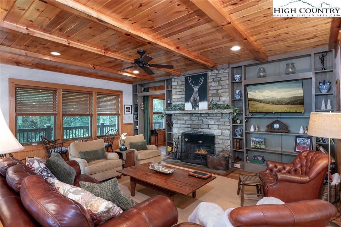 a living room with furniture a flat screen tv and a fireplace