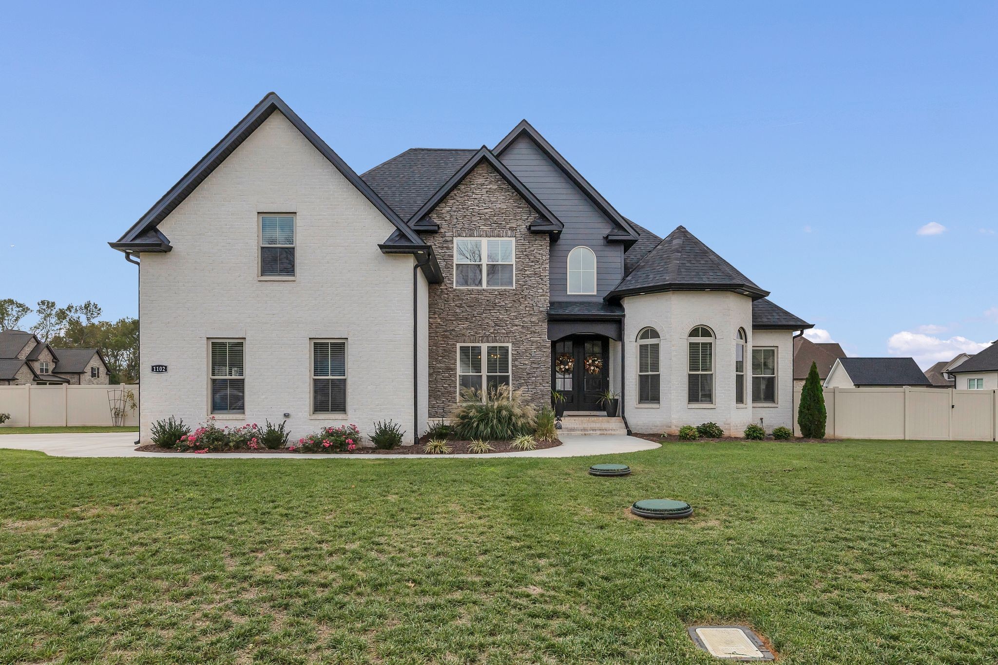 a front view of house with yard and green space