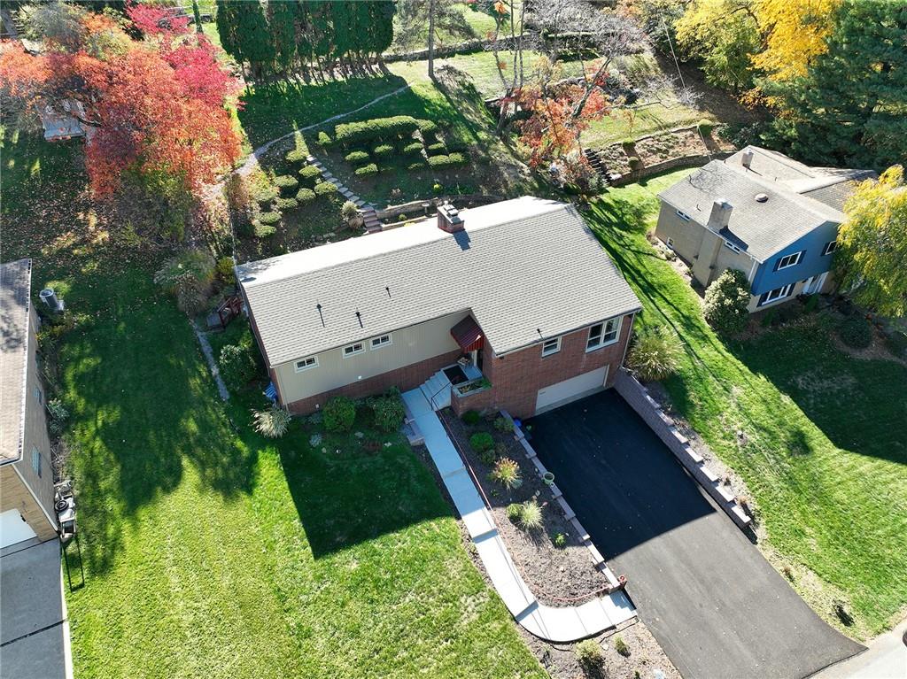 an aerial view of a house with a yard basket ball court and outdoor seating