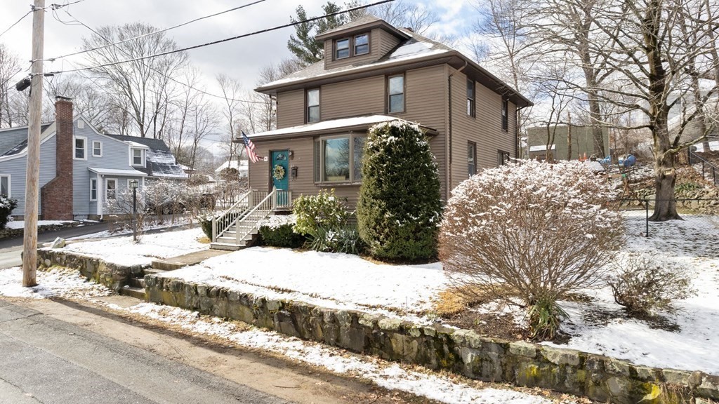 a view of a house with snow on the road