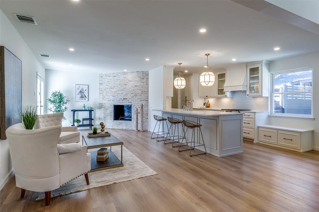 a living room with fireplace furniture and a wooden floor