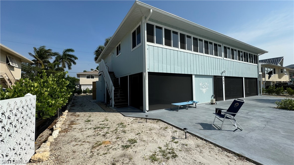 a view of a house with backyard and sitting area