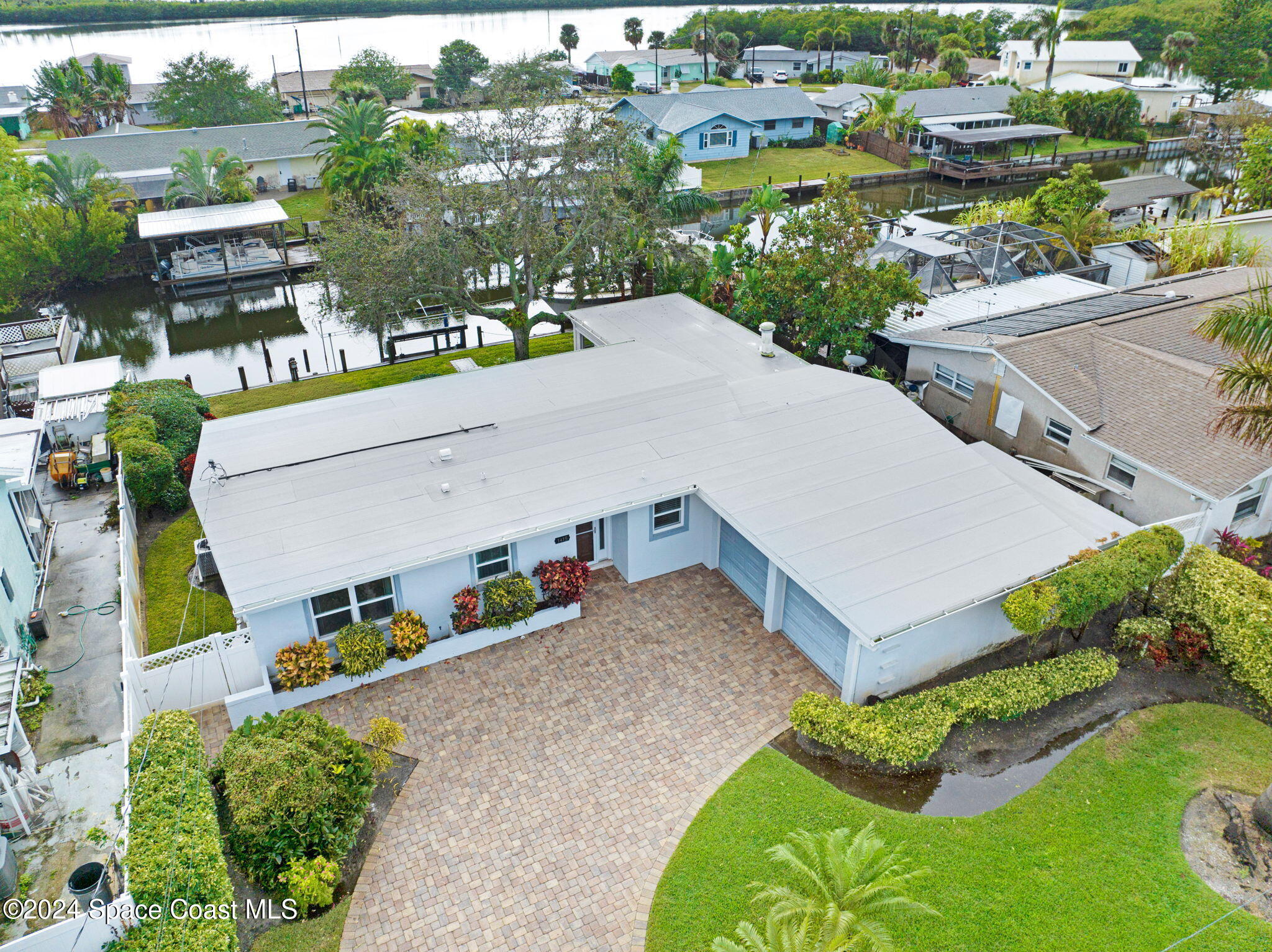 an aerial view of a house with a yard and lake view