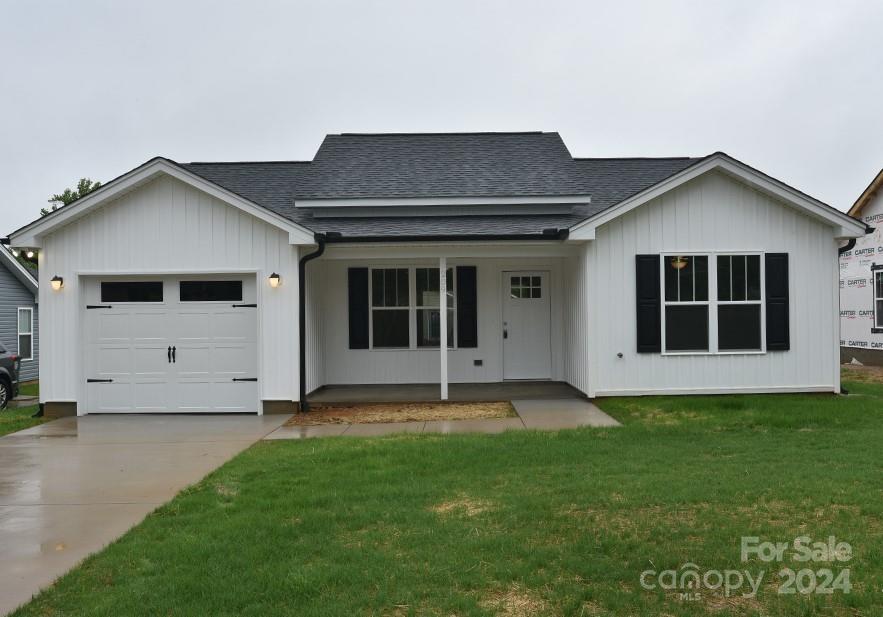 a view of an house with backyard space and a yard