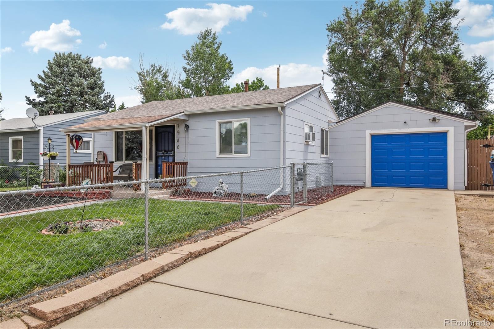 a view of a house with a backyard and a garden