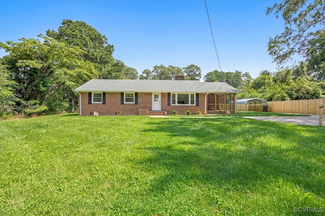 Single story home with a carport and a front yard