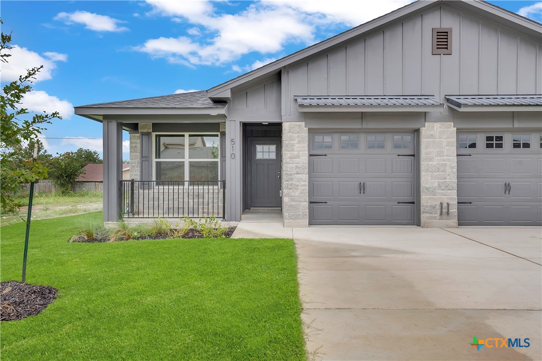 a front view of a house with a yard and garage