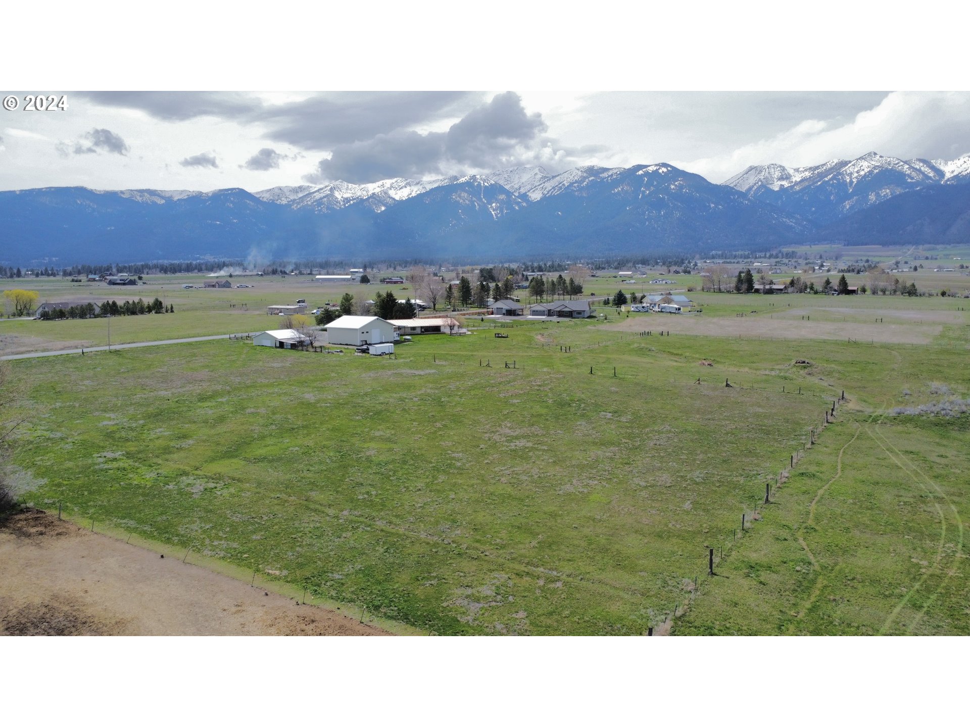 a view of an aerial view of residential houses with outdoor space and mountain view