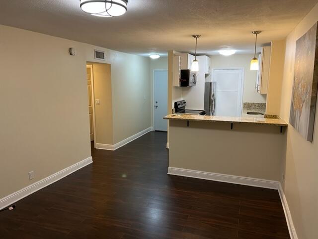 a view of kitchen with wooden floor