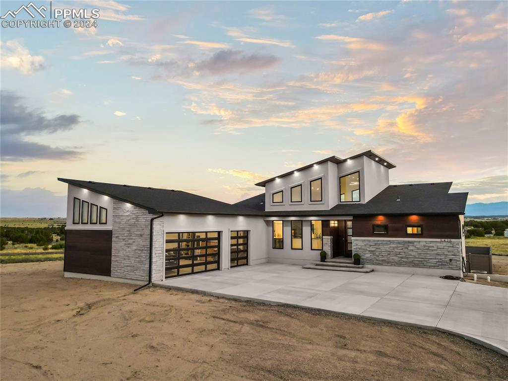 a front view of a house with a yard and garage