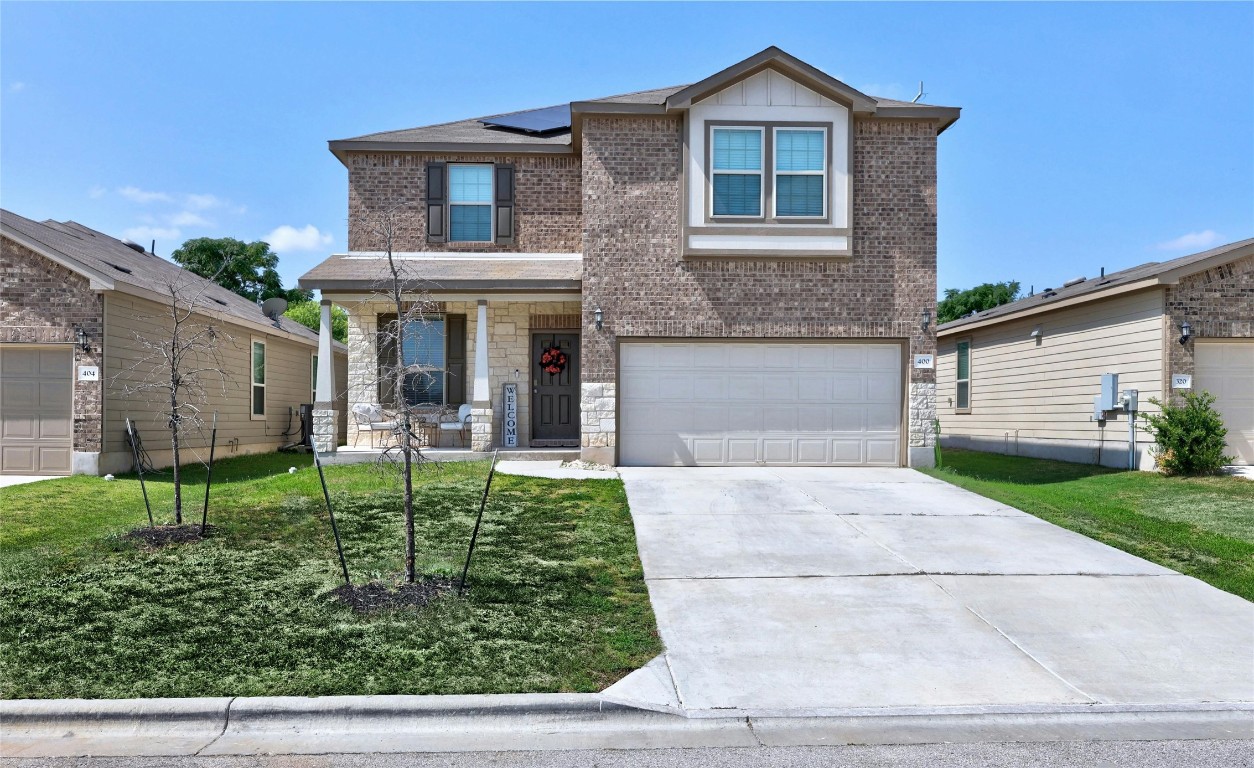 a front view of a house with garden