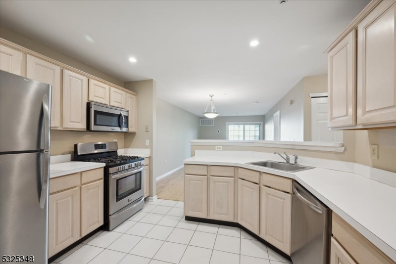 a kitchen with a sink appliances and cabinets