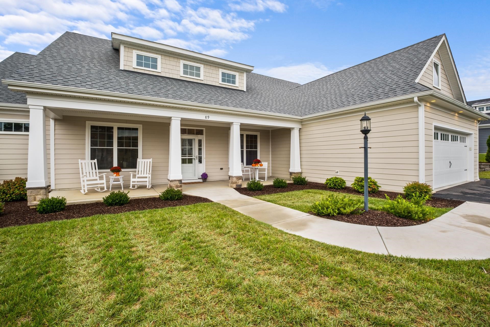 a front view of a house with yard and outdoor seating