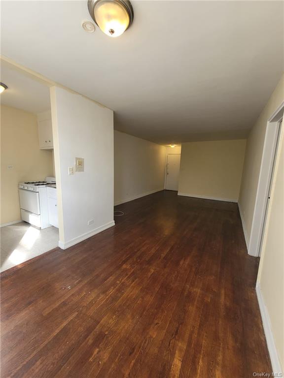 a view of an empty room and wooden floor