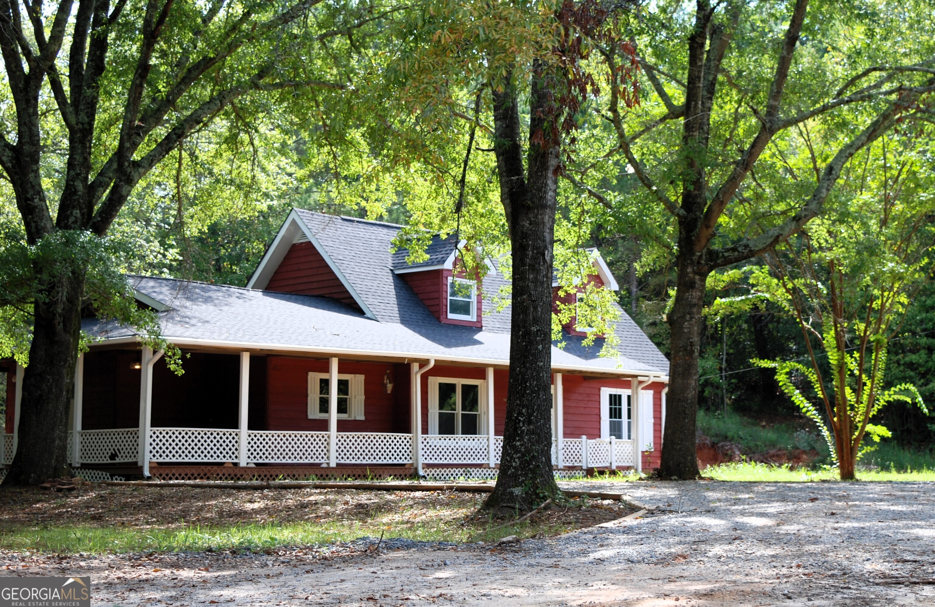 a view of a house with a tree in front of it