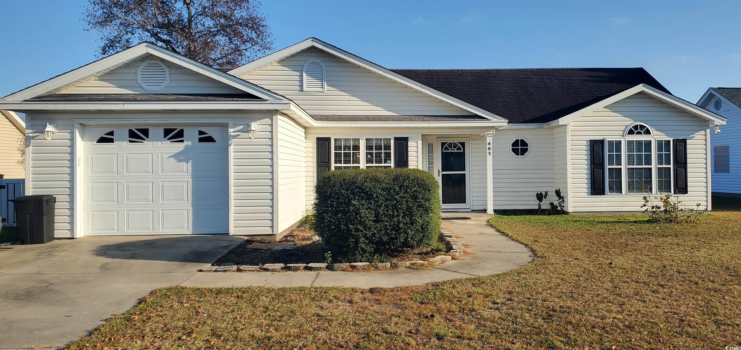 Ranch-style home with a front lawn and a garage