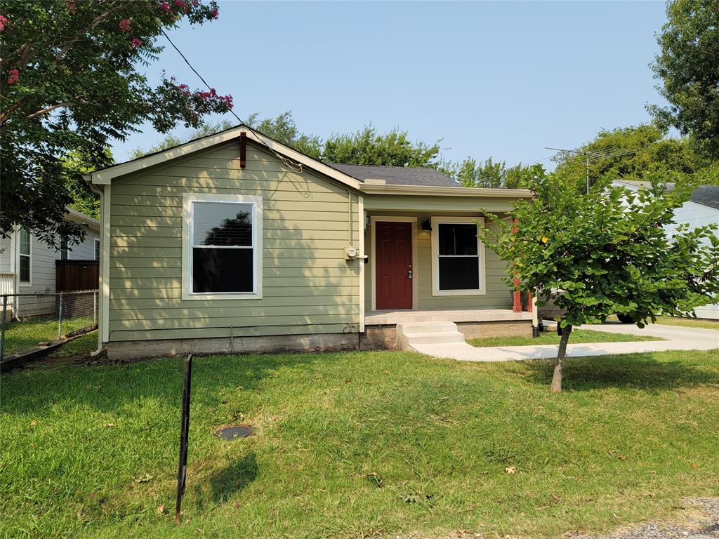 a view of backyard of house with green space