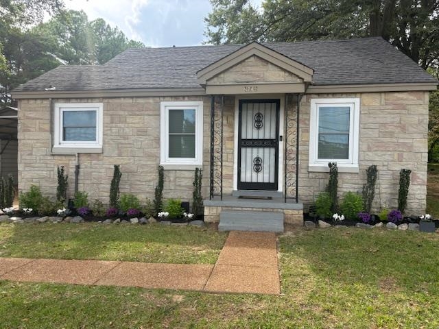 a front view of a house with garden