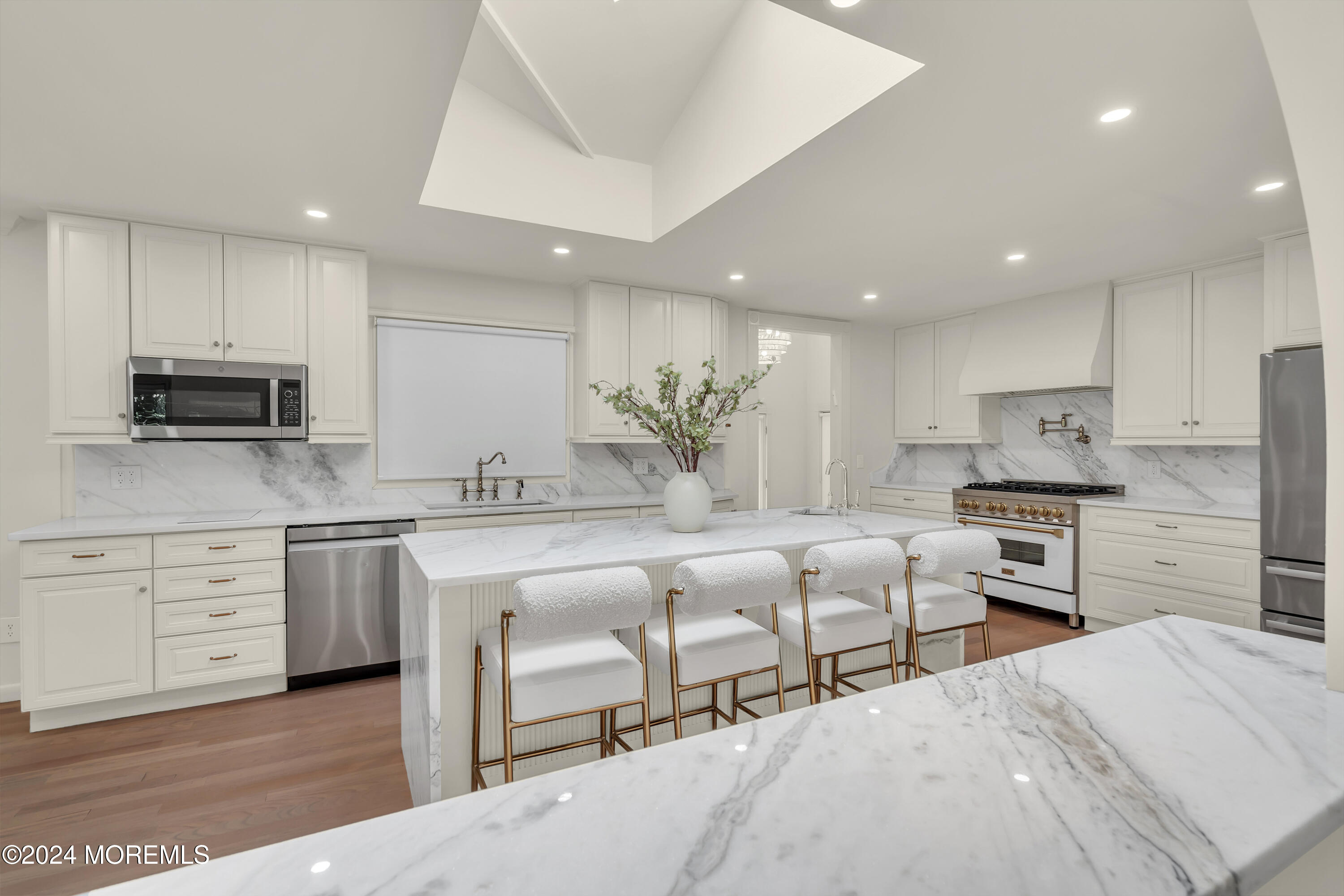 a kitchen with white cabinets and stainless steel appliances