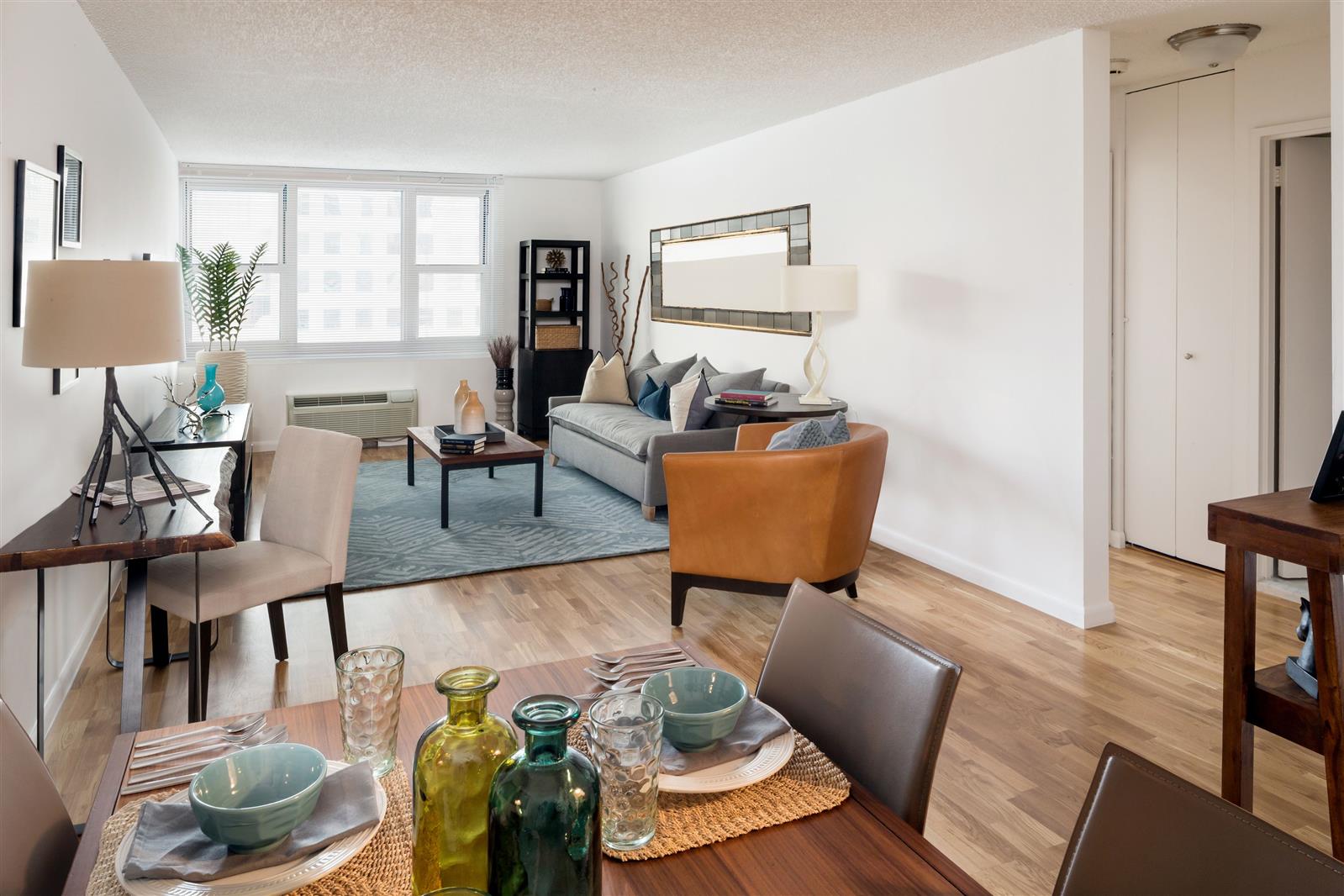 a living room with furniture and wooden floor