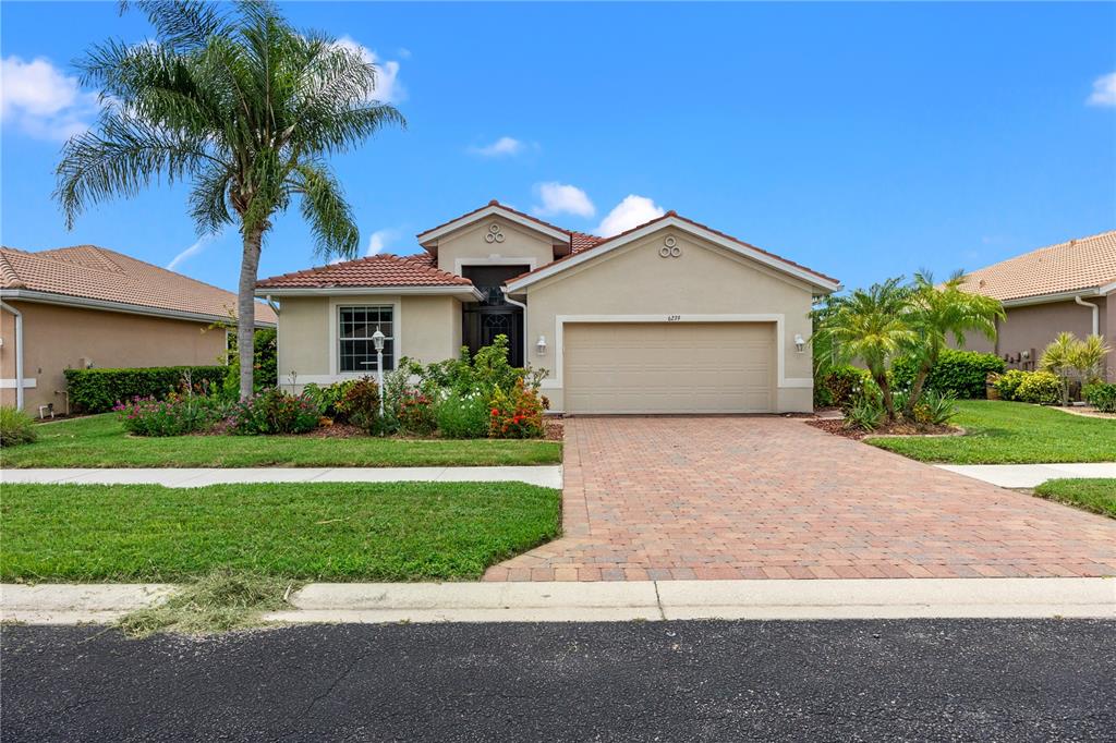 a front view of a house with a yard and garage