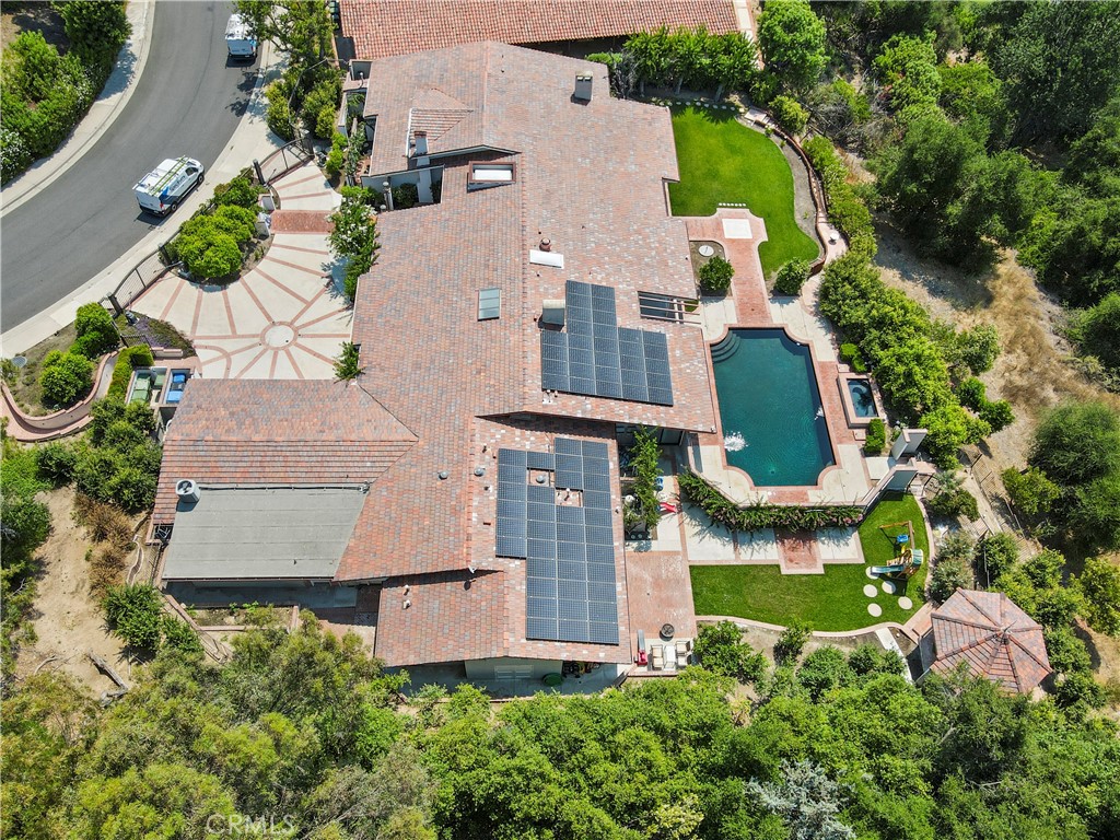 an aerial view of a house with yard swimming pool and outdoor seating