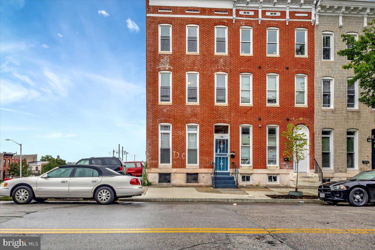 a view of a car is parked in front of a building