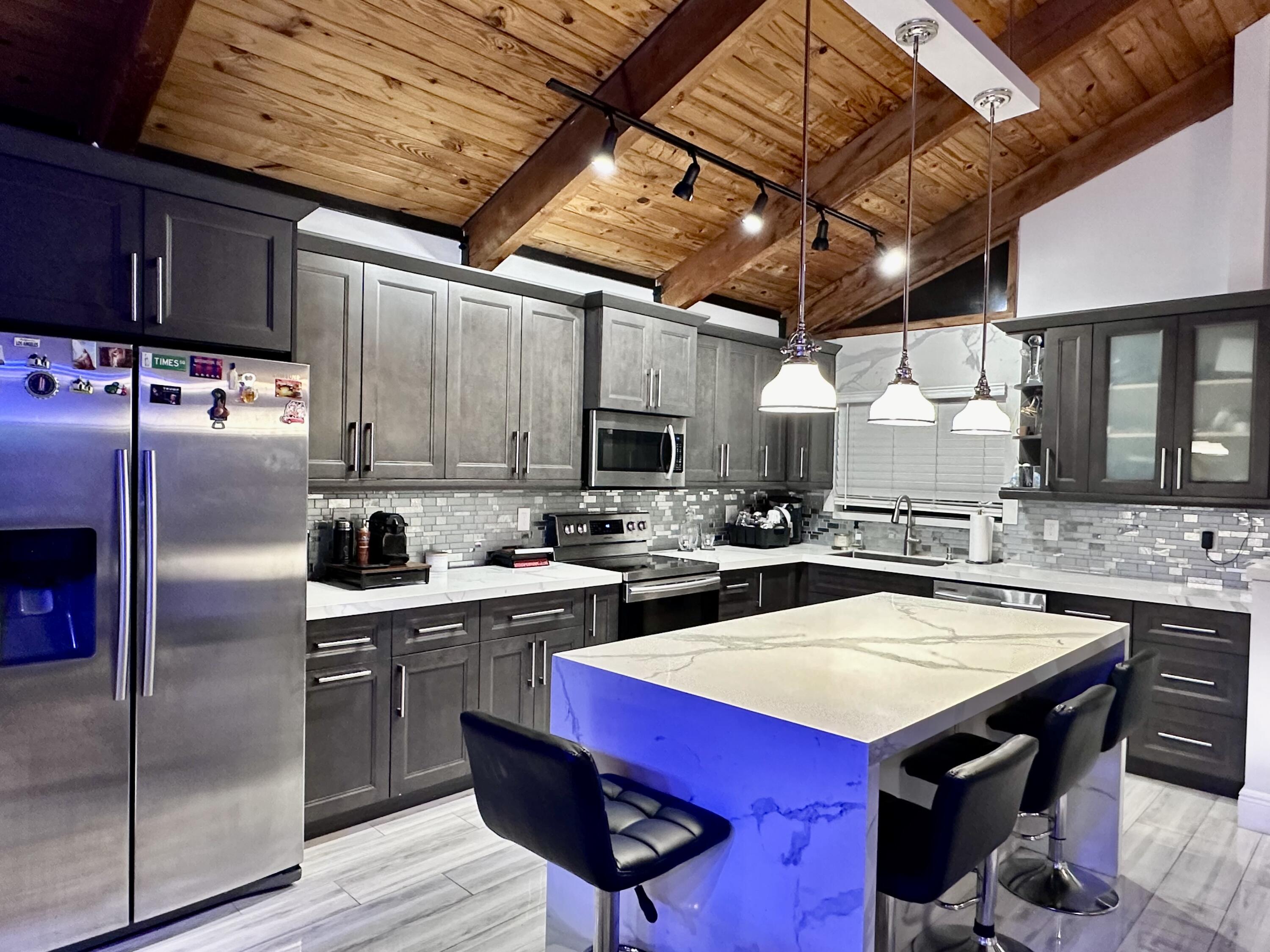 a kitchen with a sink a counter and chairs