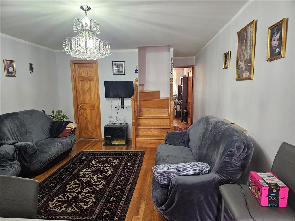 a living room with furniture and a chandelier