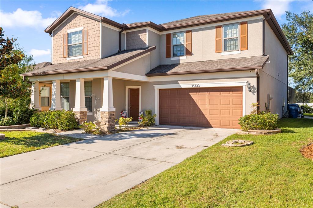 a front view of a house with a yard and garage