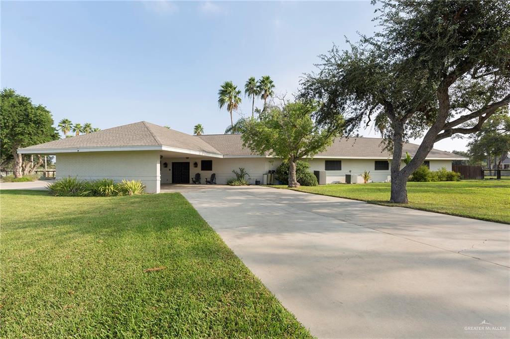 a front view of house with yard and green space